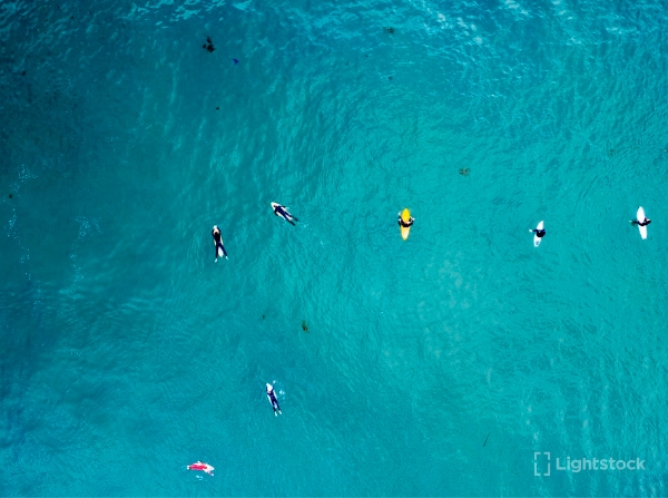 surfers in blue water